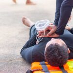 CPR on a man lying in the road