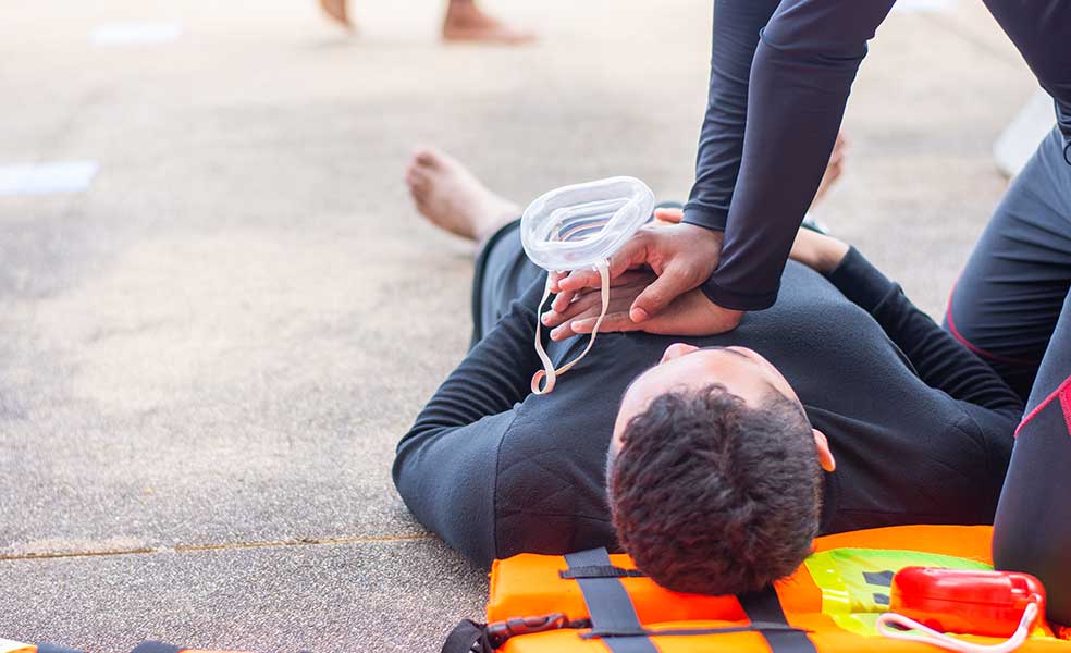 CPR on a man lying in the road